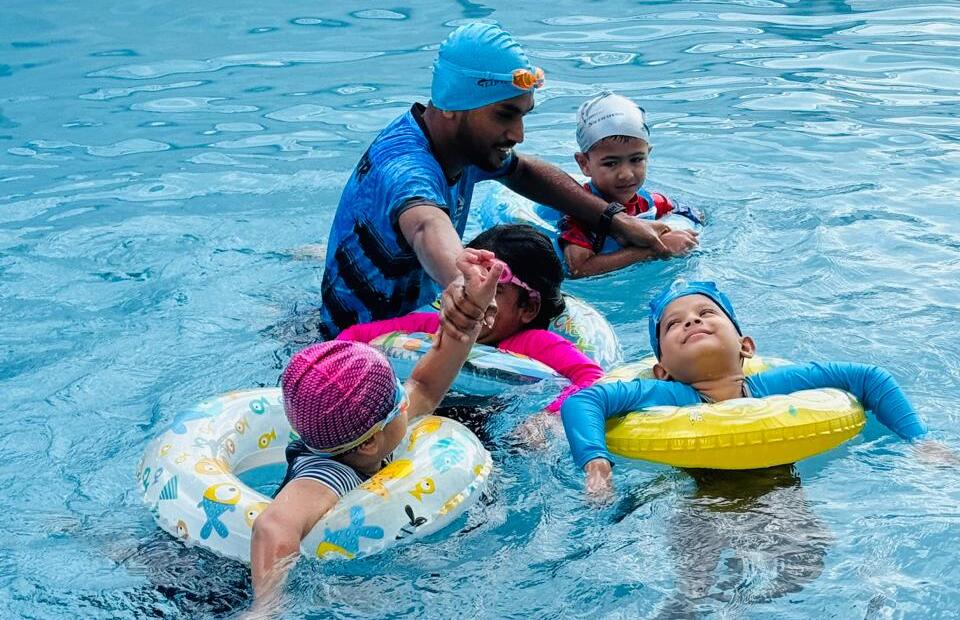 Swimmers practicing beginner to advanced pool skills